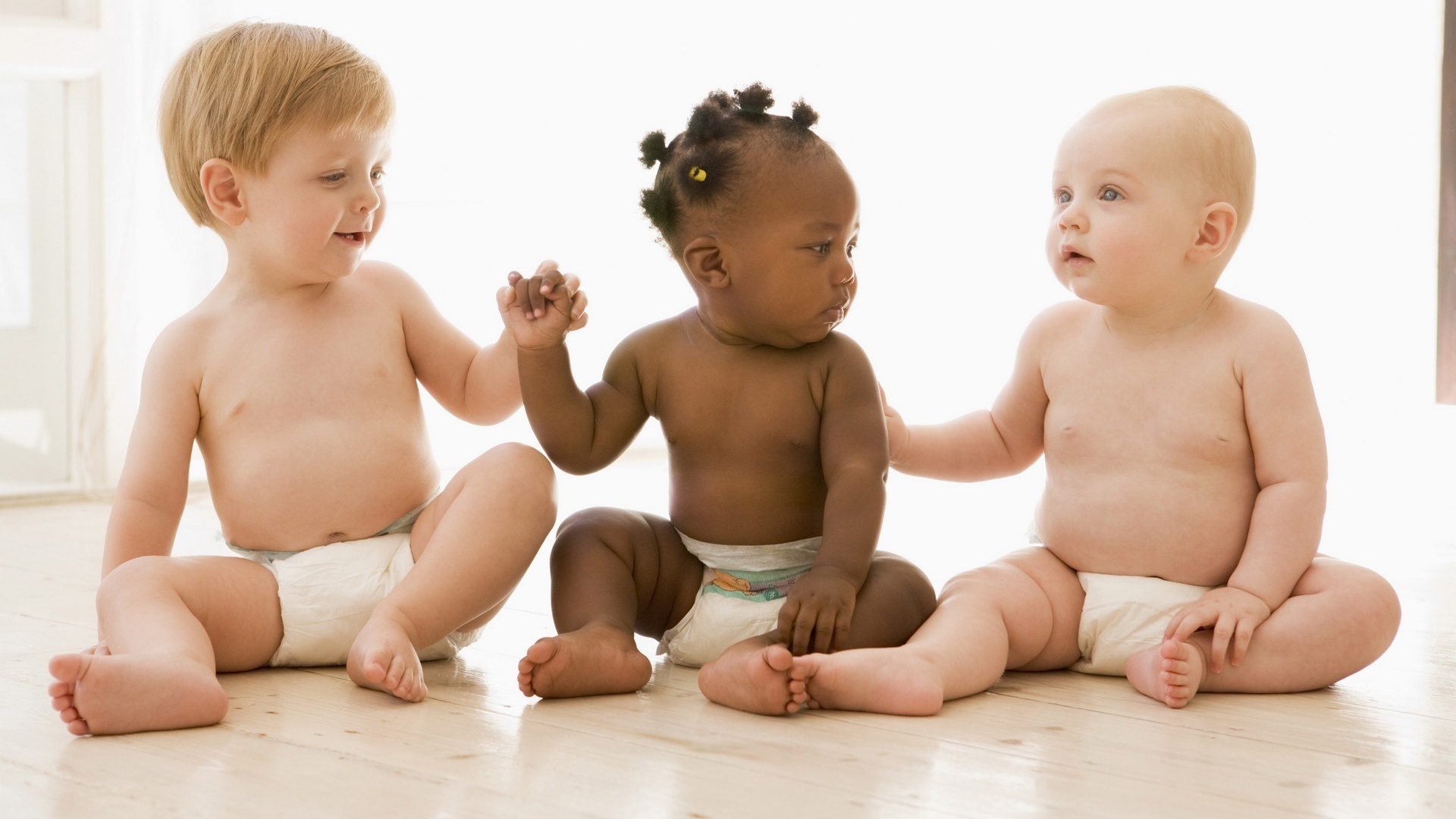 black and white babies playing together